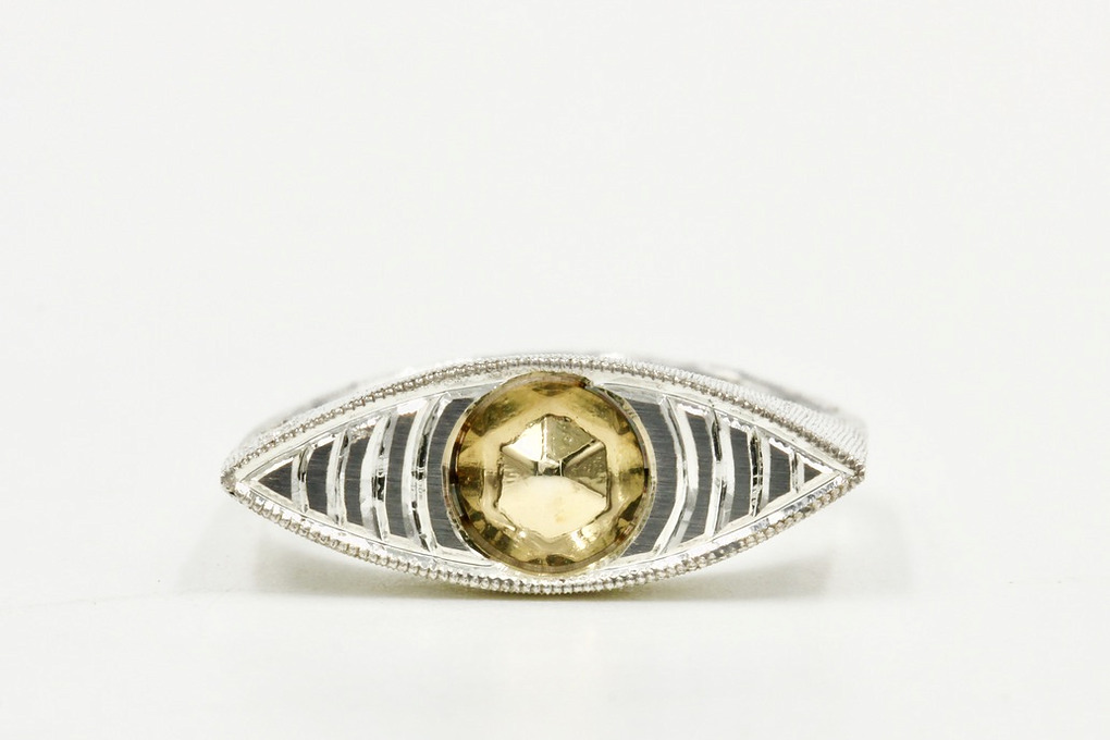Sterling Silver eye-shaped ring with a 14K faceted gold center.